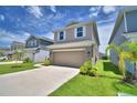 Attractive two-story home with a well-maintained lawn and a convenient two-car garage at 1417 Leamington Ln, Winter Haven, FL 33884
