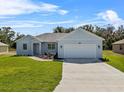 Charming home featuring a two-car garage, fresh landscaping, and a well-manicured lawn at 4502 Fairway Oaks Dr, Mulberry, FL 33860