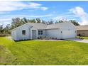 Single story home showcasing a lush green lawn, well-maintained garden, and a classic architectural style at 4502 Fairway Oaks Dr, Mulberry, FL 33860