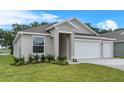Single-story home with a two-car garage, landscaped yard and welcoming curb appeal at 4541 Fairway Oaks Dr, Mulberry, FL 33860