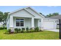 Welcoming single-story home with a manicured lawn and lovely landscaping at 4545 Fairway Oaks Dr, Mulberry, FL 33860