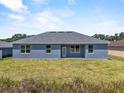 A house with a well manicured lawn in the backyard at 4550 Fairway Oaks Dr, Mulberry, FL 33860