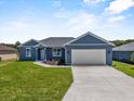 Beautiful single-story home features a well-manicured lawn, attached garage, and charming curb appeal at 4550 Fairway Oaks Dr, Mulberry, FL 33860