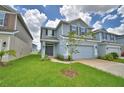 Charming two-story home with covered entryway, two-car garage and fresh landscaping at 1484 Leamington Ln, Winter Haven, FL 33884