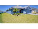 Charming one-story home boasting a manicured lawn and a side-entry two-car garage at 4938 Vue Delac Pass, Auburndale, FL 33823