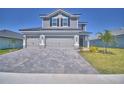 Beautiful two-story home with a three-car garage and a paver driveway at 4676 Grandview Glen Dr, Auburndale, FL 33823