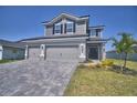 Inviting two-story home with a three-car garage and beautifully landscaped front yard at 4676 Grandview Glen Dr, Auburndale, FL 33823