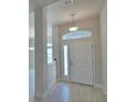 Welcoming entryway with tile flooring, a transom window, and a bright, airy feel at 5280 Tennessee Ridge Ct, Auburndale, FL 33823
