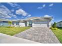 Charming single-story home with a well-manicured lawn and a paver driveway, enhancing curb appeal at 5280 Tennessee Ridge Ct, Auburndale, FL 33823