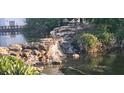 Scenic view of a community water feature with cascading waterfalls and lush greenery at 1144 Waterfall Ln # 26, Lakeland, FL 33803