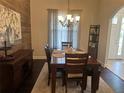 Traditional dining room features hardwood floors, chandelier lighting, and modern design at 2875 Creeks Crossing Blvd, Lakeland, FL 33810