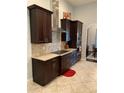 Modern kitchen with stainless steel appliances, granite countertops, and dark wood cabinetry at 2875 Creeks Crossing Blvd, Lakeland, FL 33810