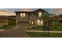 Charming two-story home featuring a brick driveway, arched entryway, and well-manicured lawn at 4184 Prima Lago Cir, Lakeland, FL 33810