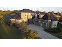 A charming two-story home with a three-car garage and a well-manicured lawn at 7330 Reflections Lake Dr, Lakeland, FL 33813