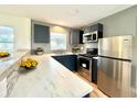 Modern kitchen with stainless steel appliances and bright white marble countertops at 3523 Colleen Dr, Lakeland, FL 33810