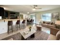 Inviting living room with stylish furniture, tile floors and a kitchen bar perfect for entertaining guests at 3523 Colleen Dr, Lakeland, FL 33810