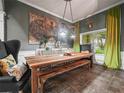 Elegant dining room featuring a large wooden table, industrial light fixtures, and unique wall decor at 1096 Drew St, Lakeland, FL 33810