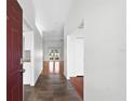 Welcoming foyer with tiled floor transitioning to hardwood; bright, open space at 123 Ruby Lake Dr, Winter Haven, FL 33884