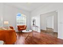 Cozy living room with hardwood floors, bright window, and comfortable seating at 123 Ruby Lake Dr, Winter Haven, FL 33884