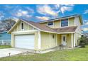 Two-story house with a large window and a neatly landscaped yard at 1426 Persimmon Way, Lakeland, FL 33811