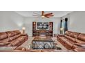 Relaxing living room with brown leather sofas and a built-in entertainment center at 5528 Arlington River Dr, Lakeland, FL 33811