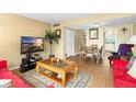 Living room with wood floors, comfy furniture, and a view of the dining area at 1920 E Edgewood Dr # G5, Lakeland, FL 33803