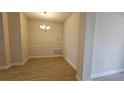 Formal dining room with decorative trim and modern chandelier at 4544 Grand View Glen Dr, Auburndale, FL 33823