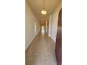 Bright foyer with wood-look tile flooring leading to open living spaces at 4544 Grand View Glen Dr, Auburndale, FL 33823