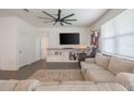 Living room with sectional sofa, TV, and built-in shelving at 296 Spirit Landings Cir, Winter Haven, FL 33880