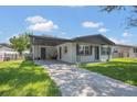 Charming single-story home with a covered carport and a well-maintained lawn at 602 Taylor Blvd, Winter Haven, FL 33880