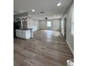 Spacious living room featuring wood-look floors, recessed lighting, and abundant natural light at 602 Taylor Blvd, Winter Haven, FL 33880