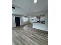 Open-concept living room featuring vinyl flooring and views of the kitchen bar at 602 Taylor Blvd, Winter Haven, FL 33880