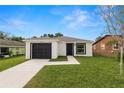 Charming single story home with black garage door and modern exterior paint at 1918 Dr Martin L King Jr Way, Haines City, FL 33844