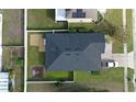 Aerial view of a well-maintained property featuring a dark roof and a fenced backyard at 1109 Brenton Manor Dr, Winter Haven, FL 33881