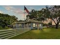 Charming single-story home with a red door and a white picket fence as dusk approaches at 1705 Davis Ave, Bartow, FL 33830
