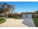 Charming single Gathering home with a well-manicured lawn, mature trees and a two car garage at 1865 15Th Nw Ct, Winter Haven, FL 33881