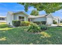 Charming single-story home featuring well-manicured landscaping and an attached two-car garage at 511 Alcazar Ct, The Villages, FL 32159