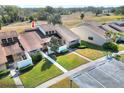 Aerial view of the townhome showcasing mature landscaping, private driveway, and ample parking at 5225 Imperial Lakes Blvd # 27, Mulberry, FL 33860