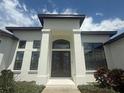 Elegant home entrance featuring double doors with decorative glass and decorative columns at 5074 Shore Side Dr, Lakeland, FL 33812