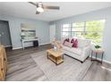 Stylish living room boasts modern flooring, a large window, neutral colors, and contemporary decor accents at 1220 Woodland Ave, Lakeland, FL 33801