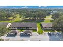 Aerial view of the community showing well maintained lawns, mature trees, and covered parking at 2256 Firestone Pl, Winter Haven, FL 33884