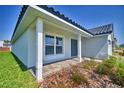 Home exterior with a tiled roof and covered entryway, complemented by neatly landscaped surroundings at 4682 Grandview Glen Dr, Auburndale, FL 33823