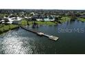 Aerial view of a long wooden dock or pier stretching out onto a beautiful lake at 5514 Maggiore Blvd, Lakeland, FL 33805