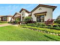 Attractive single-Gathering home with a manicured lawn, tile roof, and lush landscaping at 3000 Sanctuary Cir, Lakeland, FL 33803
