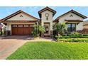 Beautiful home featuring a well-manicured lawn and a two-car garage at 3000 Sanctuary Cir, Lakeland, FL 33803