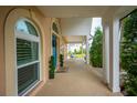 Inviting front porch with brick floor and white columns, offering a peek at the charming rocking chairs at 5009 Hanover Ln, Lakeland, FL 33813
