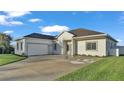 Well-maintained single-Gathering home featuring a two-car garage and a spacious concrete driveway at 570 Gandhi Dr, Lakeland, FL 33813