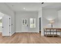 Bright living room featuring wood floors, white trim, a stylish console table, and lots of light at 570 Gandhi Dr, Lakeland, FL 33813