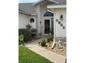 Inviting front porch of this beautiful home featuring well-maintained landscaping and stylish exterior design elements at 5982 Crane Dr, Lakeland, FL 33809