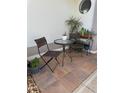 Cozy outdoor patio area with stylish seating, plants and a round window detail at 5982 Crane Dr, Lakeland, FL 33809